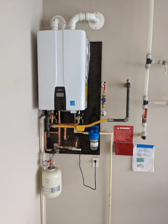 Professional plumber installing copper piping in a French Island home